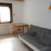 Zimmer im Gasthaus Bethlehem mit Sofa und Tisch